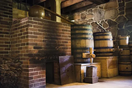 A fire box, still and barrels at George Washington's Distillery. Washington's Distillery had five copper pot stills.