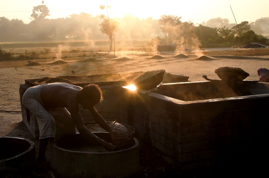 A Farmer In The Midst Of Boiling The Paddy A Stage Of Paddy