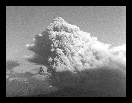 A black and white archival photo of a volcanic eruption.