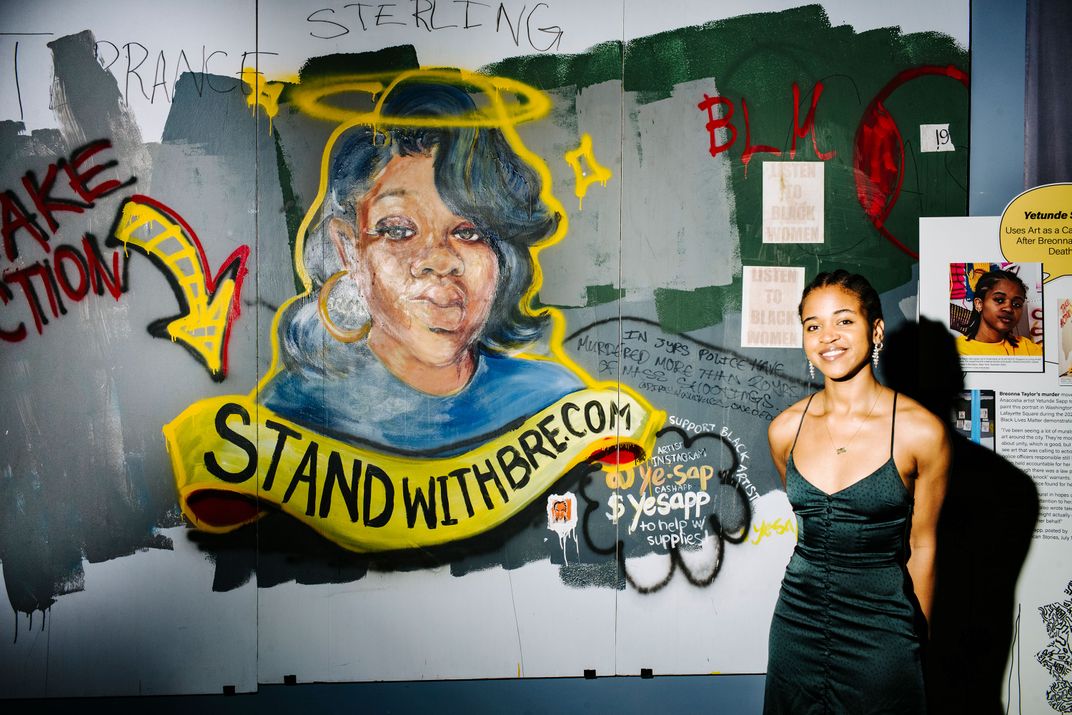 Artist Yetende Sapp with her mural of Breonna Taylor