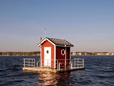 Like an iceberg, the little red hut bobbing on Sweden’s Lake Malaren hardly hints at what’s beneath the surface; some 10 feet below is the “second” floor.