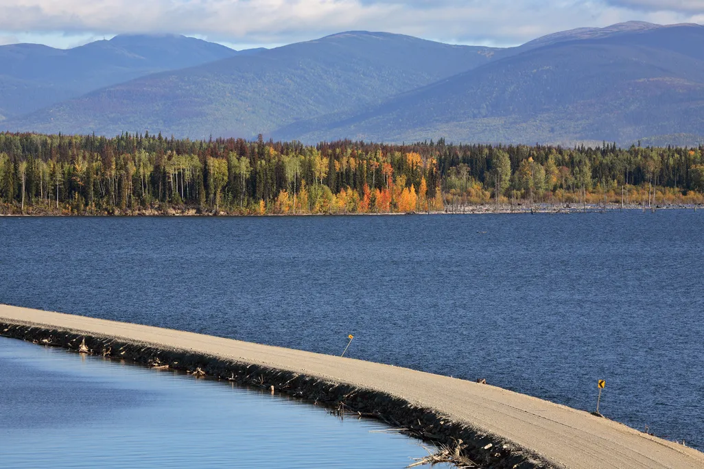 causeway over lake with mountains in the background