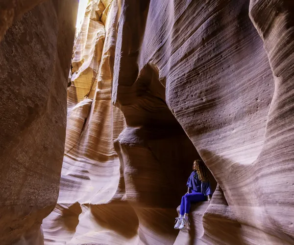 Young girl peers at the wonder of Antelope Canyon thumbnail