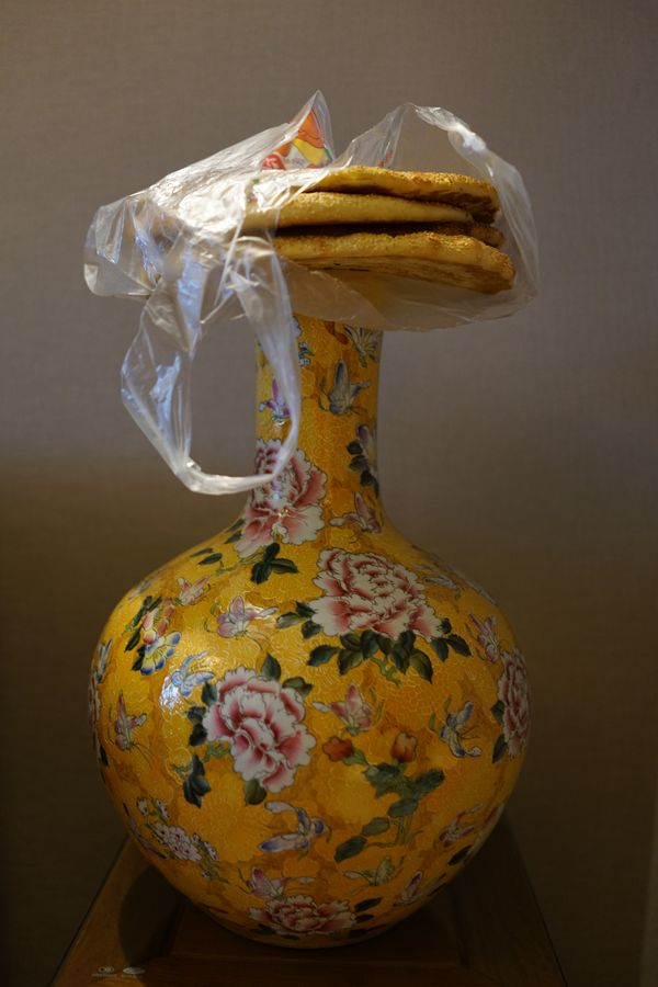 Uighur nang bread balanced on Chinese cloisonne vase thumbnail