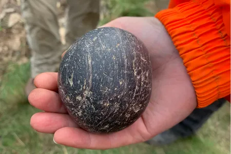 Some prehistoric stone spheres found in Scotland feature carved ridges and spirals. This one's surface is polished smooth.