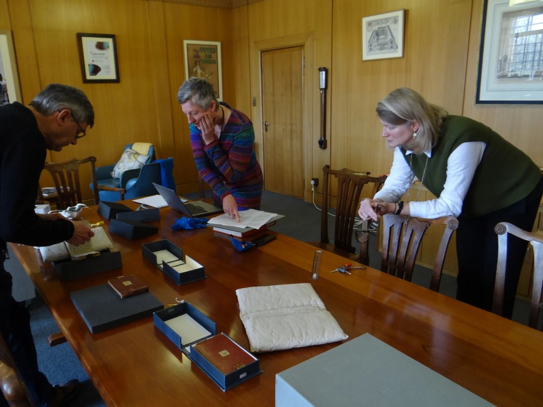 Librarians examine Darwin notebooks