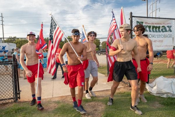 High school teenagers enter the stadium with their flags thumbnail