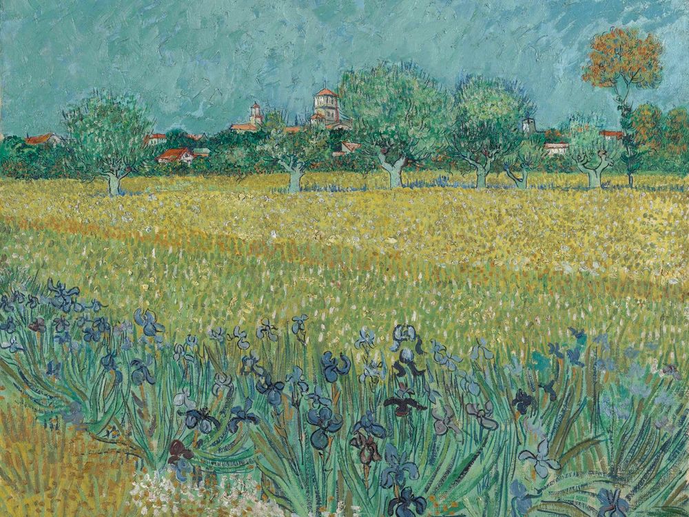 A painting of deep blue irises and a yellowish field, with a muted blue sky and trees behind