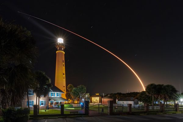 A rocket launch over a lighthouse. thumbnail