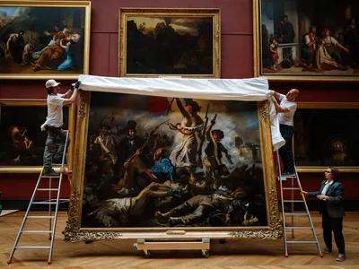 Louvre employees rehung Eugene Delacroix&#39;s 1830 oil painting&nbsp;Liberty Leading the People&nbsp;on Thursday after a six-month restoration.