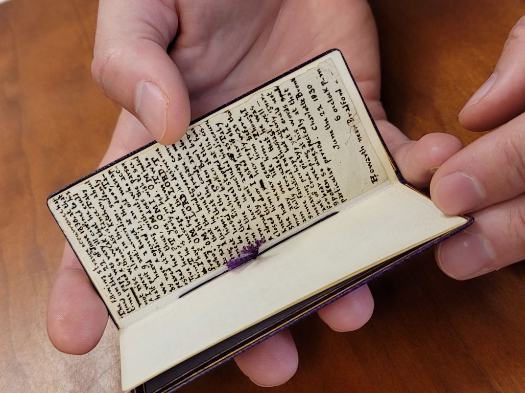 View of manuscript held by librarian