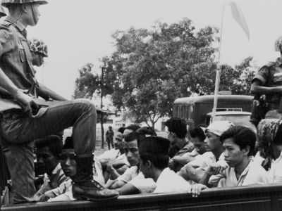 In this Oct. 30, 1965, Associated Press file photo, members of the Youth Wing of the Indonesian Communist Party (Pemuda Rakjat) are watched by soldiers as they are taken to prison in Jakarta.