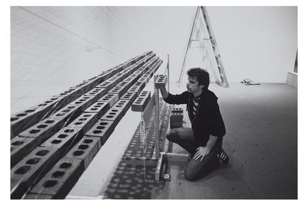Photograph of Loren Madsen with sculpture Inverted Pyramid, Floating at Hirshhorn Museum and Sculpture Garden, 1979 / unidentified photographer. Loren Madsen papers, 1969-2017. Archives of American Art, Smithsonian Institution.
