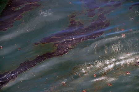 A large oil slick floats about a mile off Perdido Key, FL, where cleanup crews worked to recover the oil, Saturday, June 12, 2010.