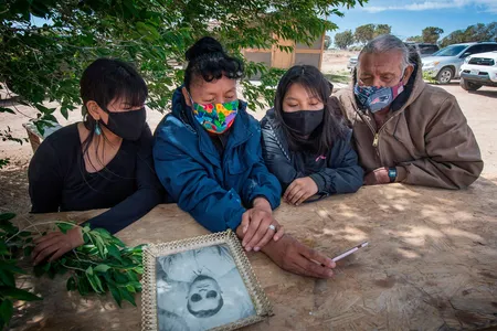The Covid-19 pandemic has exacted a heavy toll on Native American communities. In this May 2020 image, Navajo elder Emerson Gorman (R) sits with his (L-R) daughter Naiyahnikai, wife Beverly and grandchild Nizhoni near the Navajo Nation town of Steamboat in Arizona.