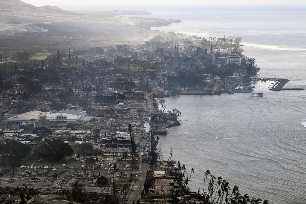 smoke floats above a scorched coastal, developed landscape