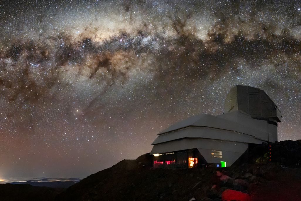 observatory on a mountain against a starry night sky