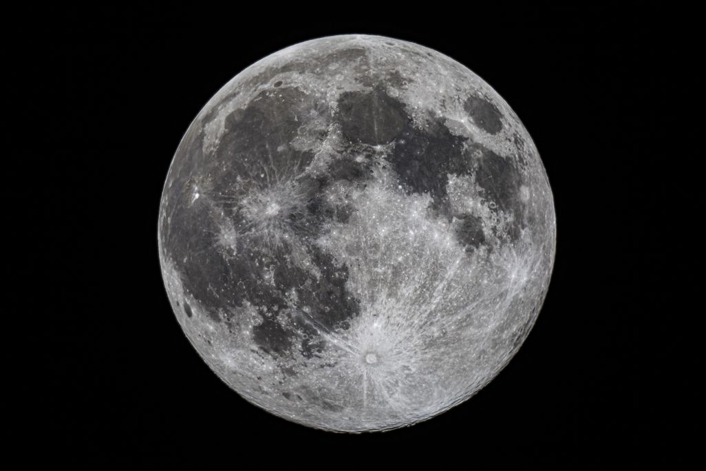the full moon against a black background