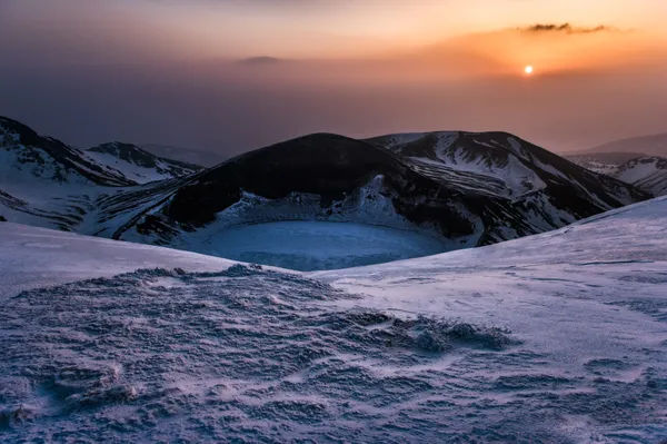 Yamagata in February. The winter was approaching the end in the flatland. I was aiming for the summit of Mt. Zao from the night. There is a beautiful crater lake, which is still an active volcano, called Goshikinuma. In the summer it is a beautiful, emerald green lake. It was covered with a fog. I was able to wait for the sun to come out to get the shot.