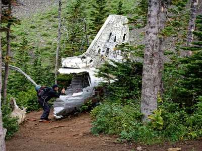 In 2014, backcountry hiker Jeff Lang photographs the tail of a downed Royal Canadian Air Force DC-3 Dakota on Mount Coulthard, Alberta, Canada. The airplane crashed in 1946 while en route from Comox, British Columbia to Greenwood, Nova Scotia, killing all seven on board.