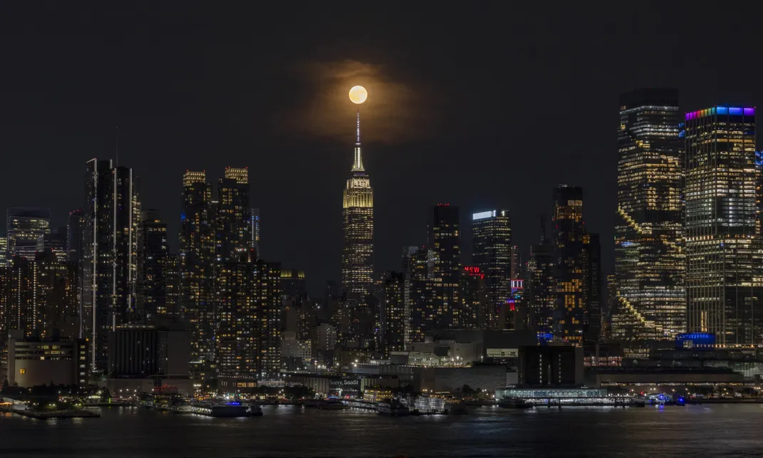 Strawberry moon rises behind the skyline of midtown Manhattan and the Empire State Building in New York City on June 29, 2026