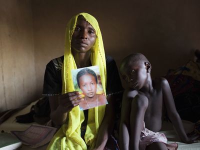Rachel Daniel, mother of one of the abducted Nigerian school girls, holds up a picture of her still-missing daughter. 