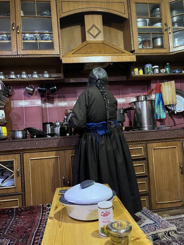 'Ama lay', the word for mother in Tibetan prepares a bowl of Chutagi, vegetables and special dumplings. thumbnail