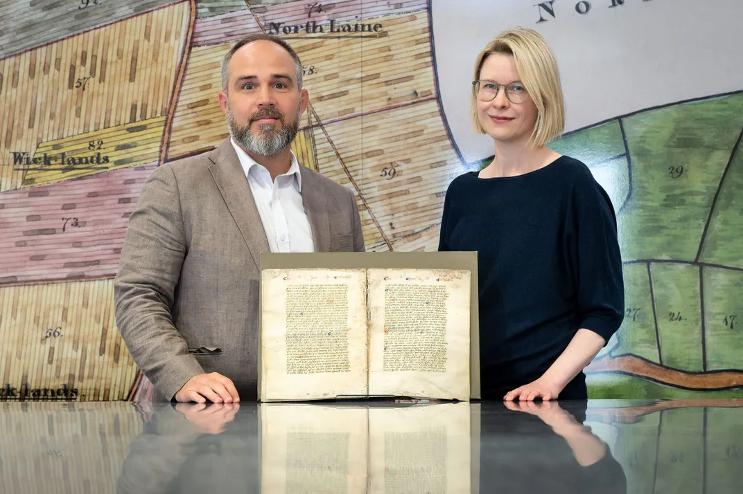 James Wade and Katie Walter with the manuscript fragment housed at the Keep archive in Brighton