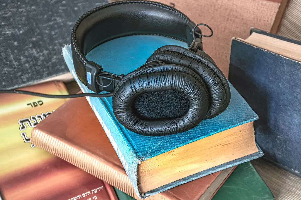 Set of headphones on a stack of books