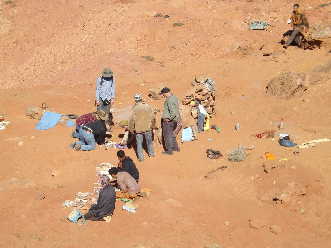 Researchers look at some fossil miners' wares.