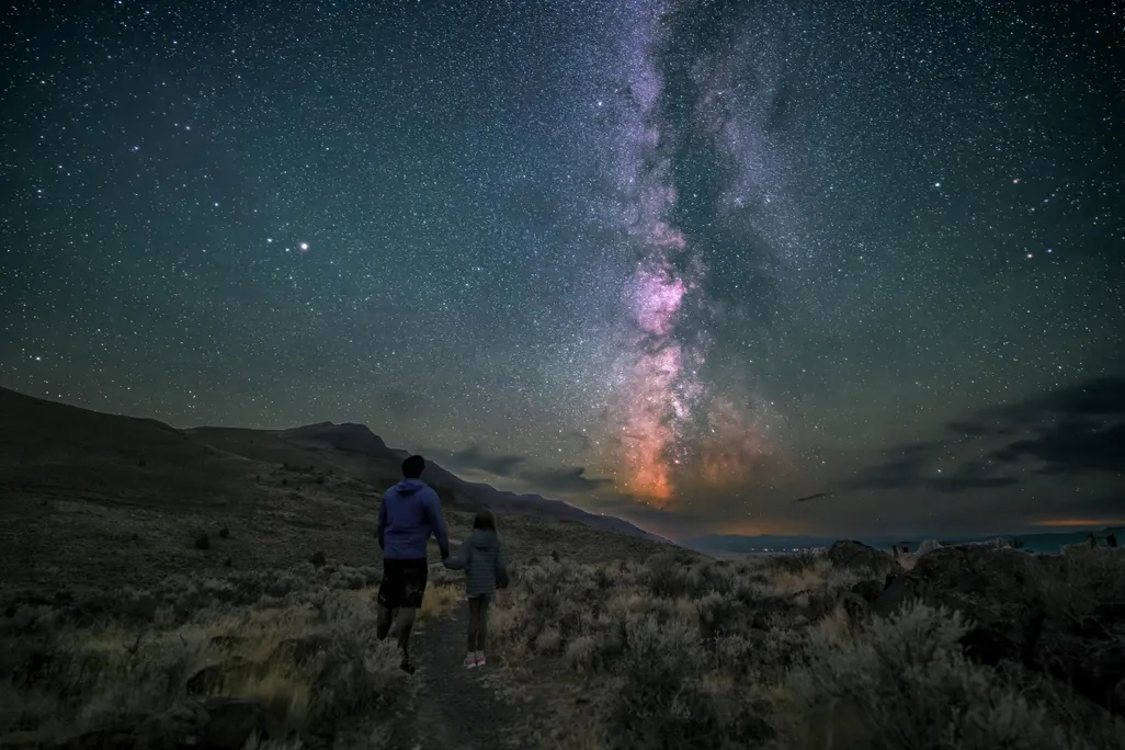 Milky Way above two people