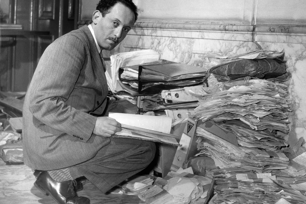 Louis de Jong, founder of NIOD examining documents on the Holocaust post-war, © Nationaal Archief Collection Spaarnestad Photo.jpg