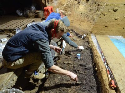 Scientists excavate bones at Bacho Kiro Cave in Bulgaria. Four modern human bones were recovered from this layer along with a rich stone tool assemblage, animal bones, bone tools and pendants.