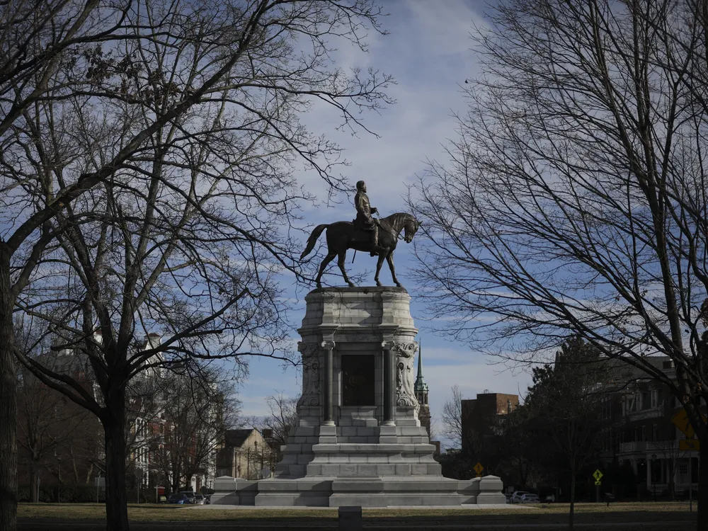 View of Richmond's Robert E. Lee monument, framed by trees, prior to its removal