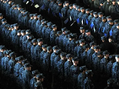 A newly promoted group of petty officers stand in formation in Yokosuka, Japan. The blue working uniforms they are wearing will start to be phased out this October.