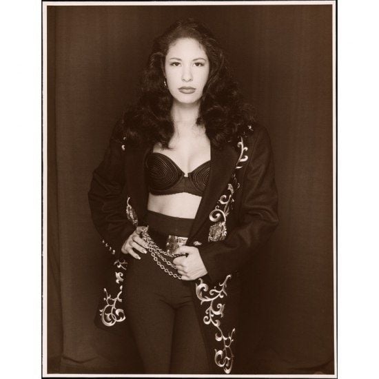 Black and white photo of Selena in black pants and embroidered jacket