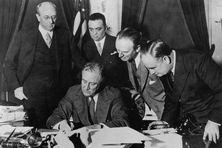 President Franklin D. Roosevelt signing a bill that gave J. Edgar Hoover and the FBI enormous power, in 1934. The bureau has been heavily involved in politics since its origin. 