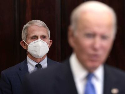 Anthony Fauci (left), director of the National Institute of Allergy and Infectious Diseases and chief medical advisor to the President, listens as President Joe Biden (right) delivers remarks on the Omicron Covid-19 variant. Fauci has warned that Omicron could reach most of the population.