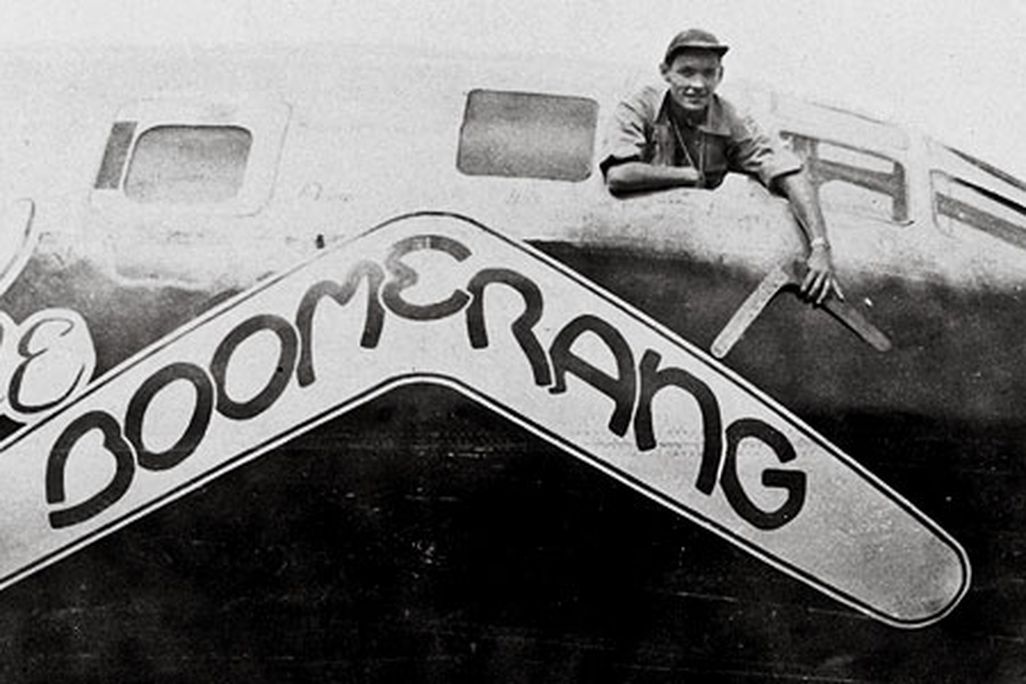 Carl Schahrer, commander of the B-29 Boomerang, shows off the talisman, on which his crew carved their missions.