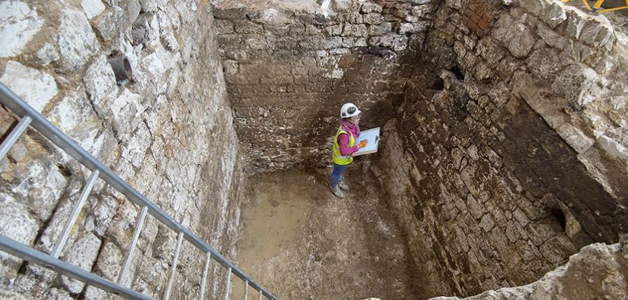 Archaeologists in cesspit