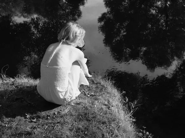 Girl sitting on riverside thumbnail