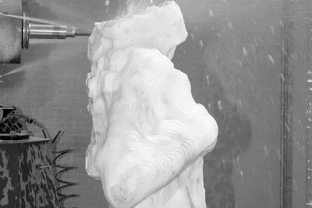 Pressurized water shoots from the drill&rsquo;s head to cool the marble and prevent excessive dust (detail).