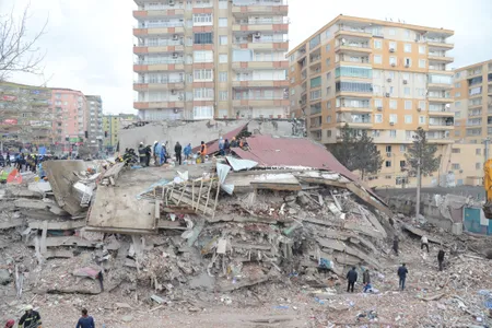 Rescue workers and volunteers conduct search and rescue operations in the rubble of a collasped building in Diyarbakir, Turkey.&nbsp;