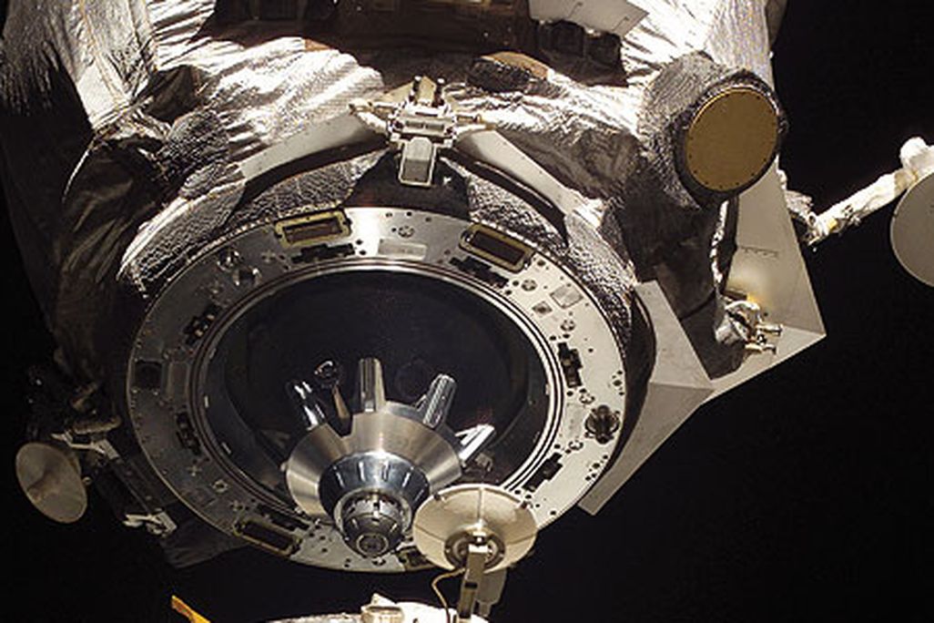 The Soyuz docking assembly's mating adapter is shown in space just feet away from the International Space Station.
