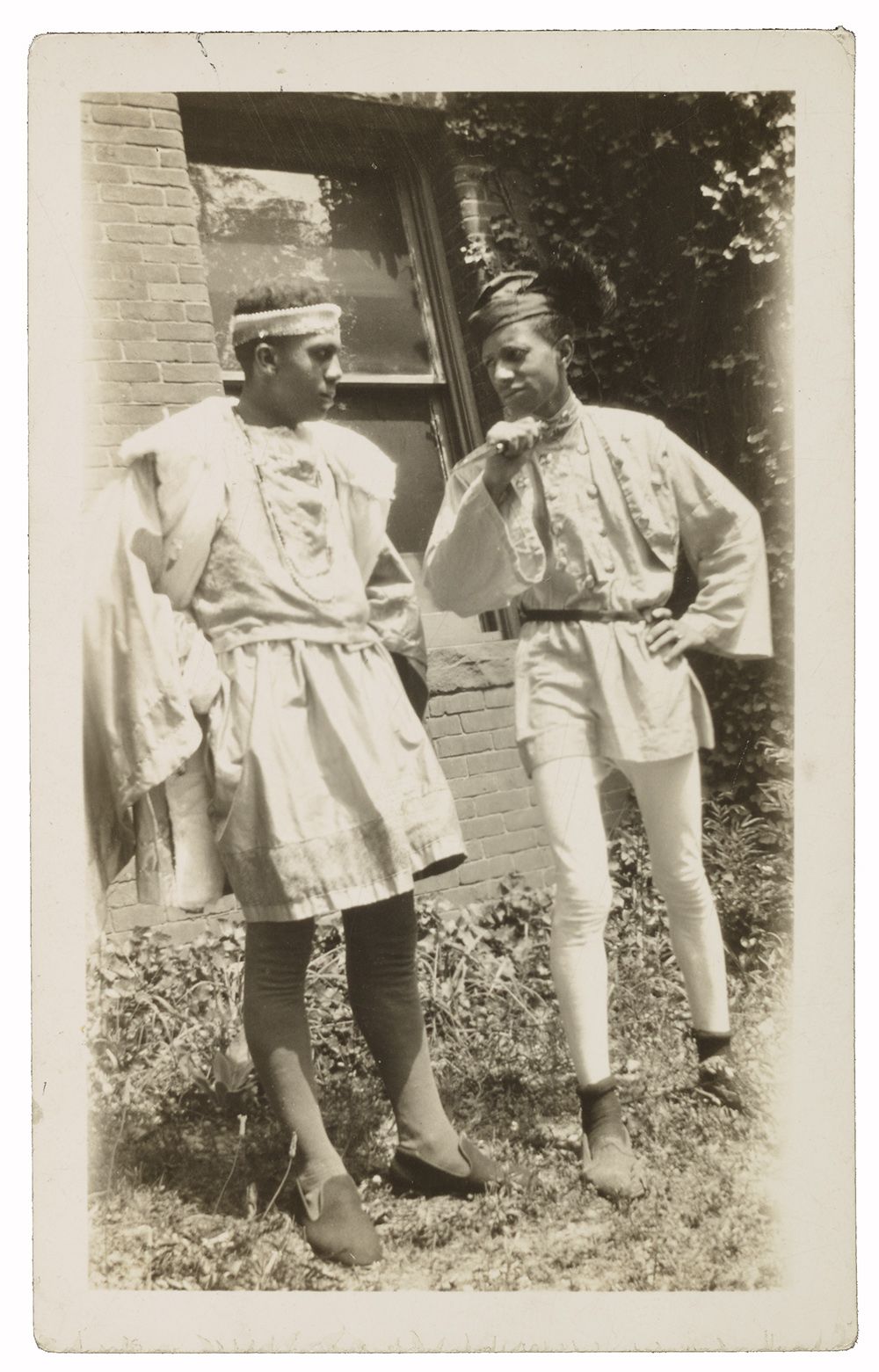 Two Howard University students wearing Renaissance-style costumes designed by Alma Thomas. 