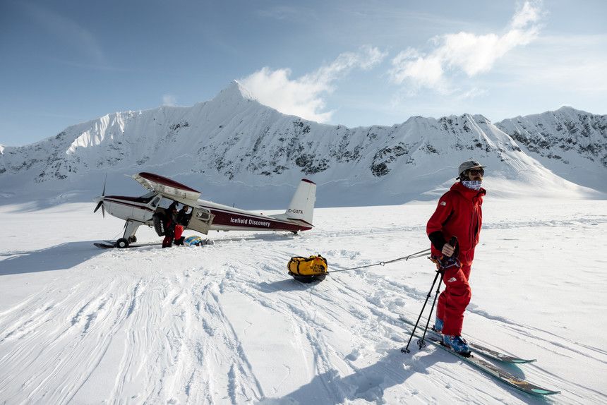 A man and an airplane on a mountain