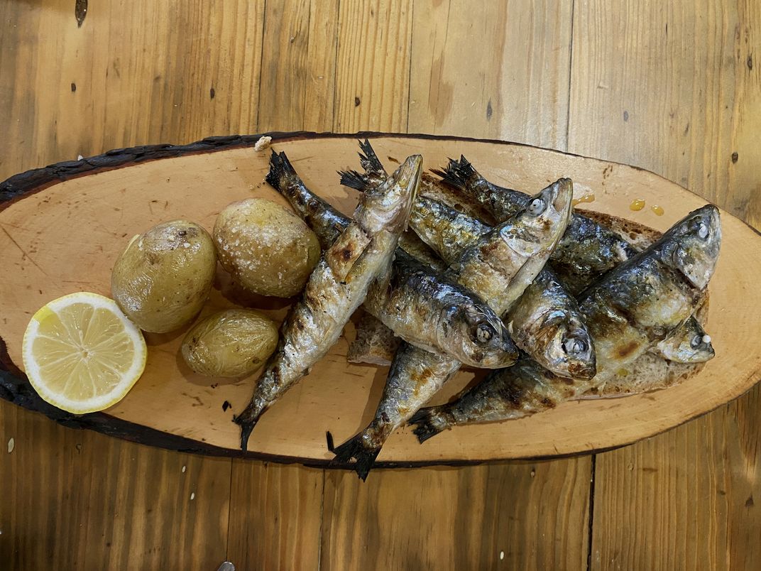 Traditional petiscos of roasted sardines and potatoes
