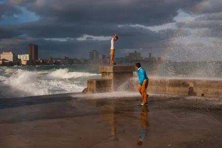 A wave splashes over the Malecón in Havana.