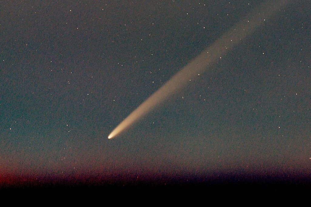 Bright comet in a dark sky.