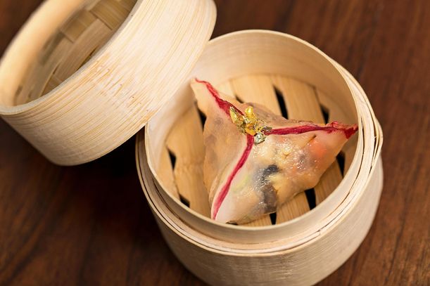 A (professionally done) imperial fungus dumpling, topped with gold leaf.